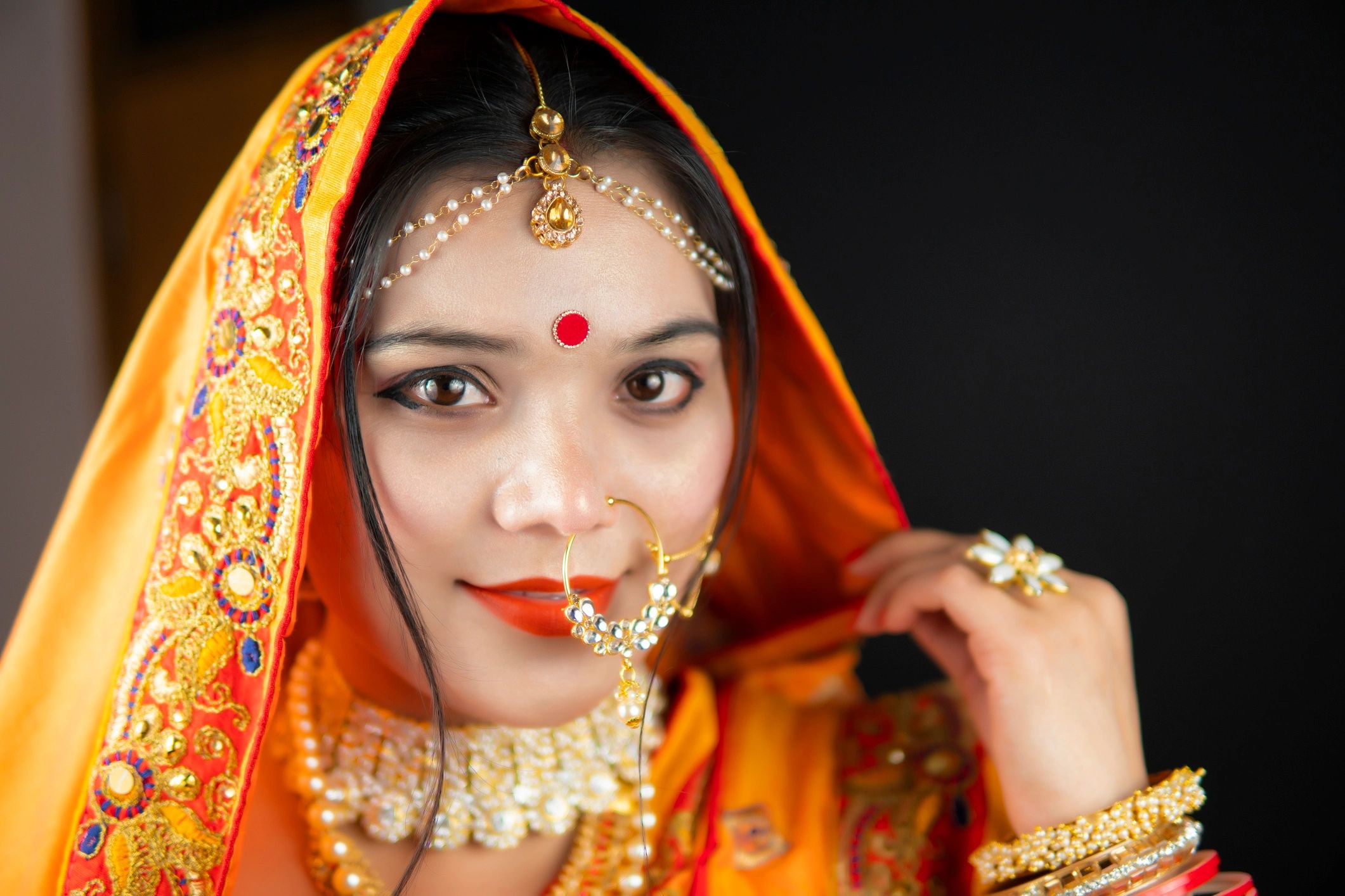 Woman in traditional attire wearing premium gold jewelry