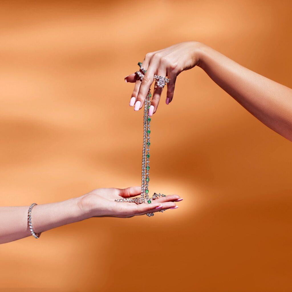 Two Hands Reaching Out, Holding Jewelry in Sincere Gesture of Connection