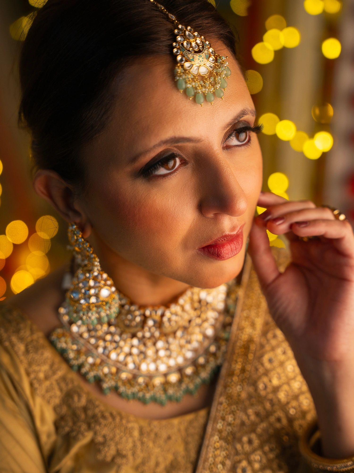 Woman in festive attire wearing ornate contemporary heritage jewelry